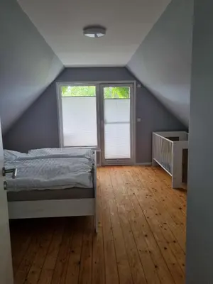 Ein Bett oder Betten in einem Zimmer der Unterkunft Ferienhaus Norderpiep 54
