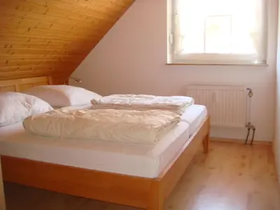 Ein Bett oder Betten in einem Zimmer der Unterkunft Haus Sandboll DHH1
