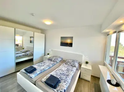 Ein Bett oder Betten in einem Zimmer der Unterkunft Terrassenhaus, FeWo 62