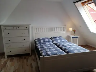 Ein Bett oder Betten in einem Zimmer der Unterkunft Wellenbude