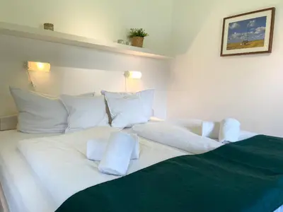 Ein Bett oder Betten in einem Zimmer der Unterkunft Haus Land & Meer FeWo14