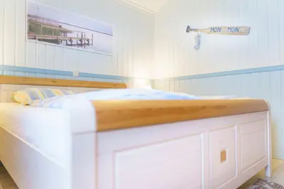 Ein Bett oder Betten in einem Zimmer der Unterkunft Ferienhaus Strandkorb