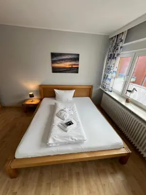 Ein Bett oder Betten in einem Zimmer der Unterkunft Hotel Tum Stüürmann
