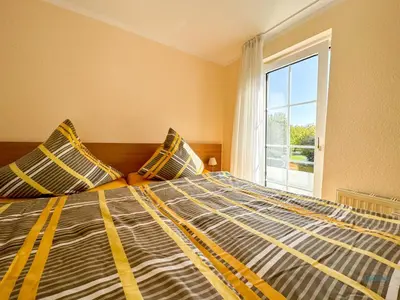 Ein Bett oder Betten in einem Zimmer der Unterkunft Haus Elbstrom Döse Whg 4