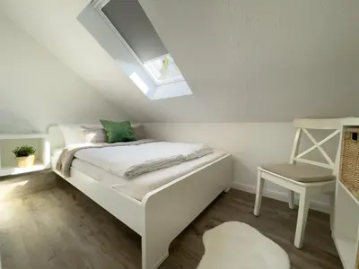 Ein Bett oder Betten in einem Zimmer der Unterkunft Kapitänshaus FeWo 3