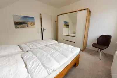 Ein Bett oder Betten in einem Zimmer der Unterkunft Haus 4Muscheln Appartement 4M2