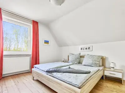 Ein Bett oder Betten in einem Zimmer der Unterkunft Haus Küstenperle