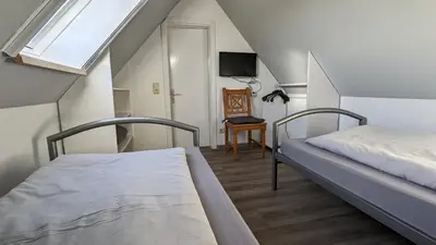 Ein Bett oder Betten in einem Zimmer der Unterkunft Dachgeschosswohnung Wilhelm
