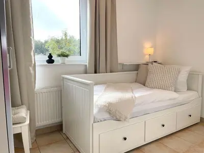Ein Bett oder Betten in einem Zimmer der Unterkunft Haus am Waldbad FeWo 21