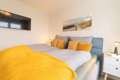 Ein Bett oder Betten in einem Zimmer der Unterkunft Dorumer Sielhuus 20