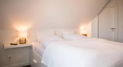 Ein Bett oder Betten in einem Zimmer der Unterkunft Haus Wellen und Meer Apartment 5