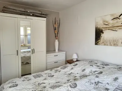 Ein Bett oder Betten in einem Zimmer der Unterkunft Küstenrose