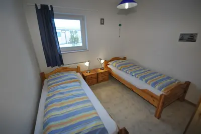 Ein Bett oder Betten in einem Zimmer der Unterkunft Ferienhaus Trio