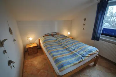 Ein Bett oder Betten in einem Zimmer der Unterkunft Ferienhaus Trio