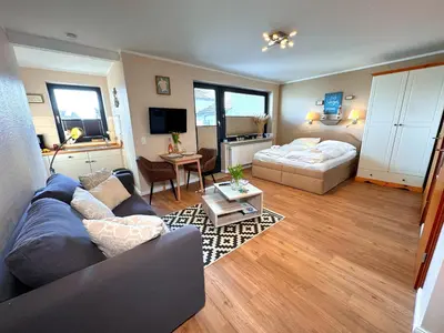 Ein Bett oder Betten in einem Zimmer der Unterkunft Outer Banks - by Mila FerienARPartments - Büsum Zentrum eigener Parkplatz Balkon