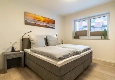 Ein Bett oder Betten in einem Zimmer der Unterkunft Ankerpunkt Südost - Dorumer Sielhuus 6