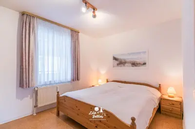 Ein Bett oder Betten in einem Zimmer der Unterkunft Haus Seemeile Whg 2 7