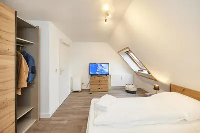 Ein Bett oder Betten in einem Zimmer der Unterkunft Stranddüne - 12