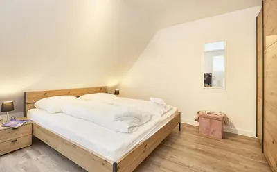 Ein Bett oder Betten in einem Zimmer der Unterkunft Stranddüne - 12