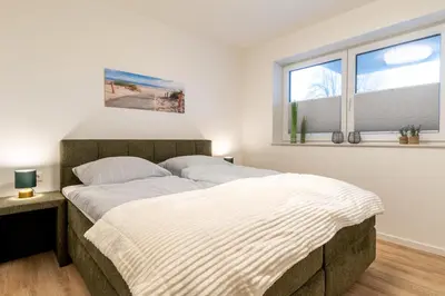 Ein Bett oder Betten in einem Zimmer der Unterkunft Nordseebrise Dorum - Dorumer Sielhuus 2