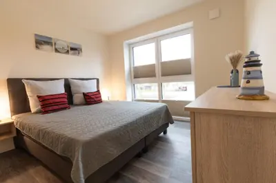 Ein Bett oder Betten in einem Zimmer der Unterkunft Nordseeglück 16 - Dorumer Sielhuus 16