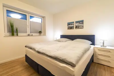 Ein Bett oder Betten in einem Zimmer der Unterkunft Dorumer Sielhuus 7
