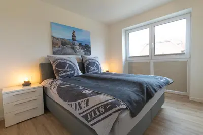 Ein Bett oder Betten in einem Zimmer der Unterkunft Dorumer Sielhuus 12