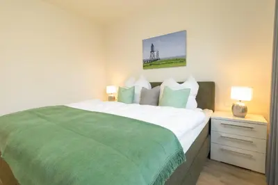 Ein Bett oder Betten in einem Zimmer der Unterkunft Dorumer Sielhuus 4