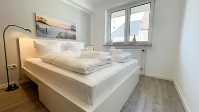 Ein Bett oder Betten in einem Zimmer der Unterkunft Nige Ooge FeWo 7
