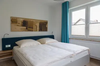 Ein Bett oder Betten in einem Zimmer der Unterkunft Apartments Christiansen