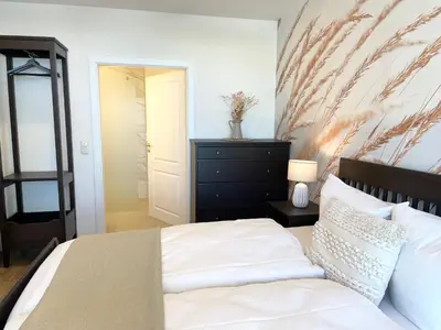 Ein Bett oder Betten in einem Zimmer der Unterkunft Haus Nordseebrandung FeWo 9