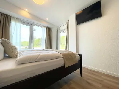 Ein Bett oder Betten in einem Zimmer der Unterkunft Haus Nordseebrandung FeWo 9