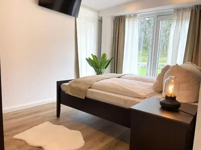 Ein Bett oder Betten in einem Zimmer der Unterkunft Haus Nordseebrandung FeWo 4