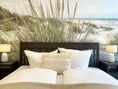 Ein Bett oder Betten in einem Zimmer der Unterkunft Haus Nordseebrandung FeWo 7