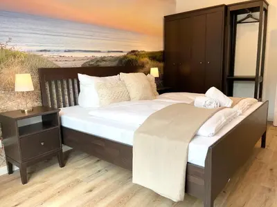 Ein Bett oder Betten in einem Zimmer der Unterkunft Haus Nordseebrandung FeWo 8