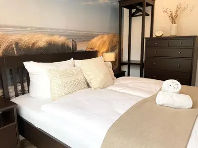 Ein Bett oder Betten in einem Zimmer der Unterkunft Haus Nordseebrandung FeWo 8