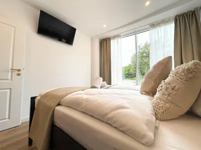 Ein Bett oder Betten in einem Zimmer der Unterkunft Haus Nordseebrandung FeWo 8