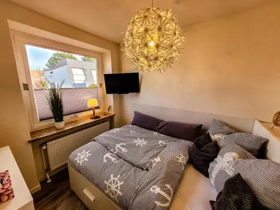 Ein Bett oder Betten in einem Zimmer der Unterkunft Ferienwohnung Duhnennest in Cuxhaven Duhnen