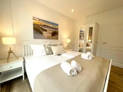 Ein Bett oder Betten in einem Zimmer der Unterkunft Haus Nordseebrandung FeWo 5