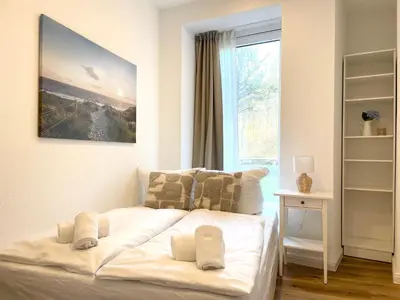 Ein Bett oder Betten in einem Zimmer der Unterkunft Haus Nordseebrandung FeWo 5