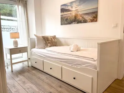 Ein Bett oder Betten in einem Zimmer der Unterkunft Haus Nordseebrandung FeWo 3