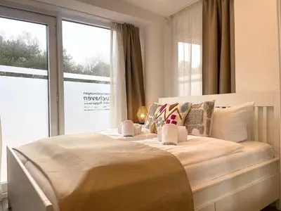 Ein Bett oder Betten in einem Zimmer der Unterkunft Haus Nordseebrandung FeWo 3