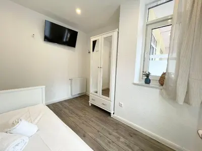 Ein Bett oder Betten in einem Zimmer der Unterkunft Haus Nordseebrandung FeWo 3