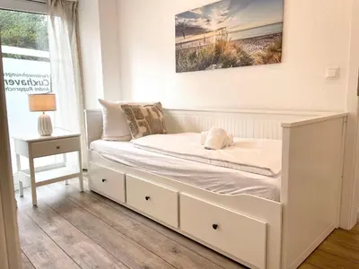 Ein Bett oder Betten in einem Zimmer der Unterkunft Haus Nordseebrandung FeWo 3