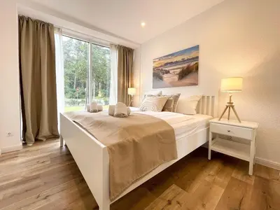 Ein Bett oder Betten in einem Zimmer der Unterkunft Haus Nordseebrandung FeWo 5