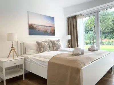 Ein Bett oder Betten in einem Zimmer der Unterkunft Haus Nordseebrandung FeWo 5