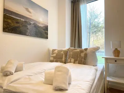 Ein Bett oder Betten in einem Zimmer der Unterkunft Haus Nordseebrandung FeWo 5