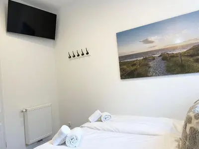 Ein Bett oder Betten in einem Zimmer der Unterkunft Haus Nordseebrandung FeWo 5