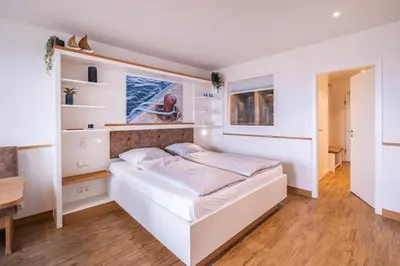 Ein Bett oder Betten in einem Zimmer der Unterkunft Hochhaus Apartment 86 MeerLounge