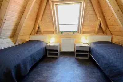 Ein Bett oder Betten in einem Zimmer der Unterkunft Ferienhaus Mellumplate 23